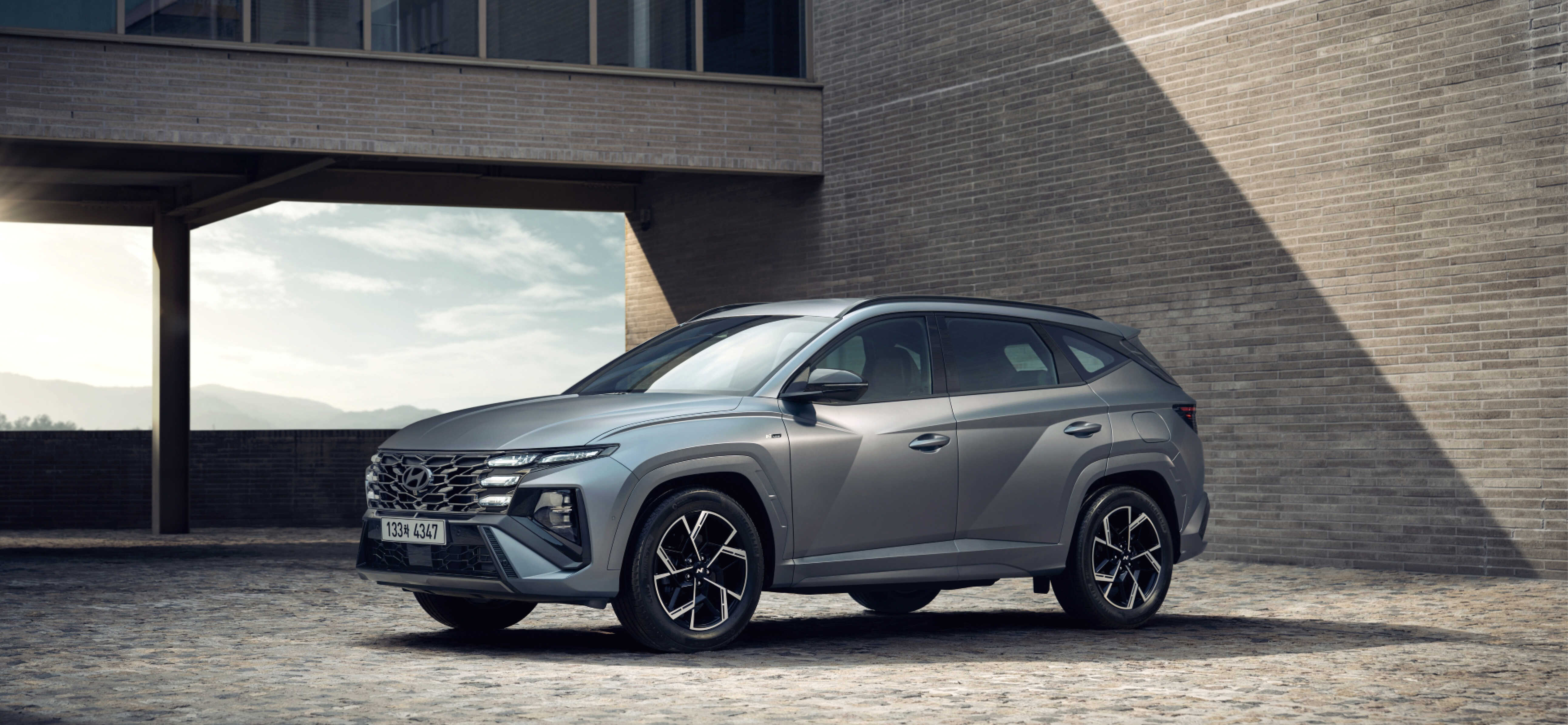 Front view of the New Tucson N Line standing against a gray building in the background