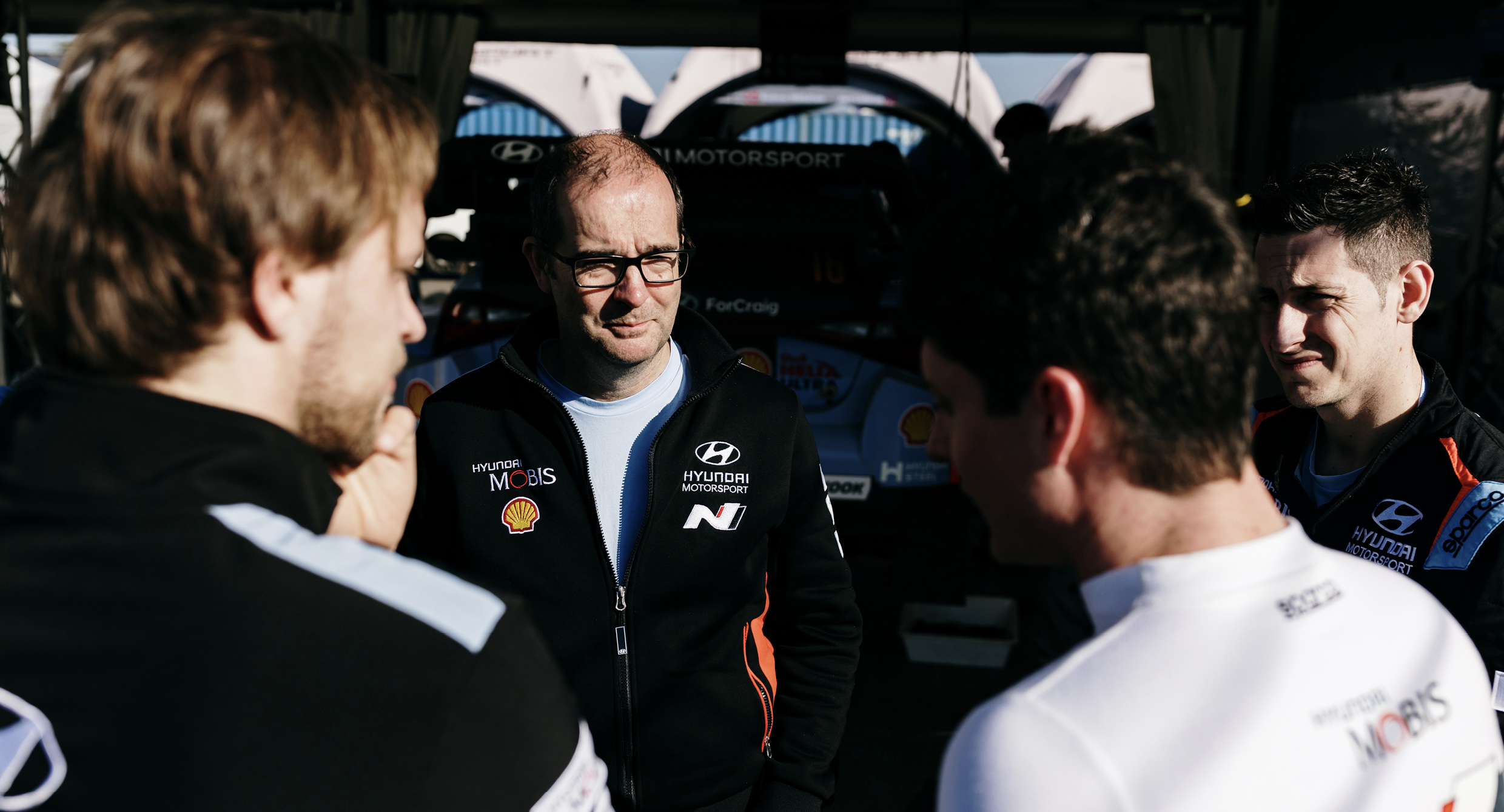 Andrew Wheatley is talking to his team members