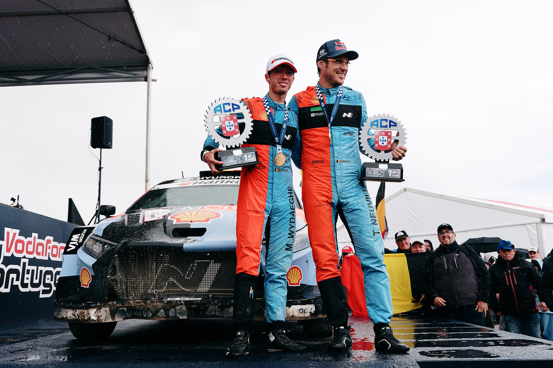 Thierry Neuville (right) and his co-driver (left) posing with a trophy