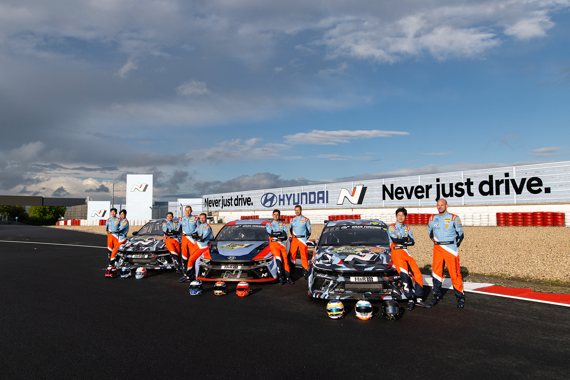 Race cars and drivers at the Nürburgring 24 Hours race venue