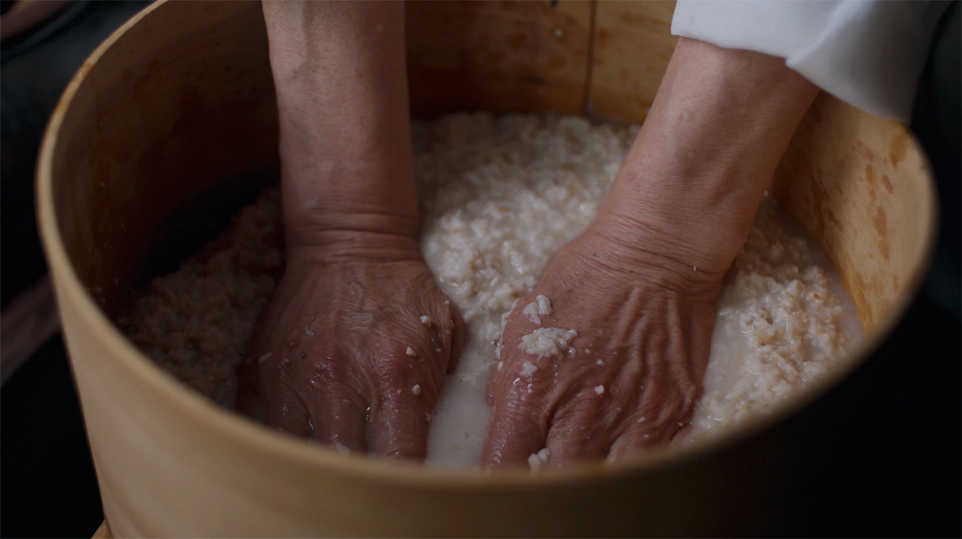 Straining the fermented mash through a sieve