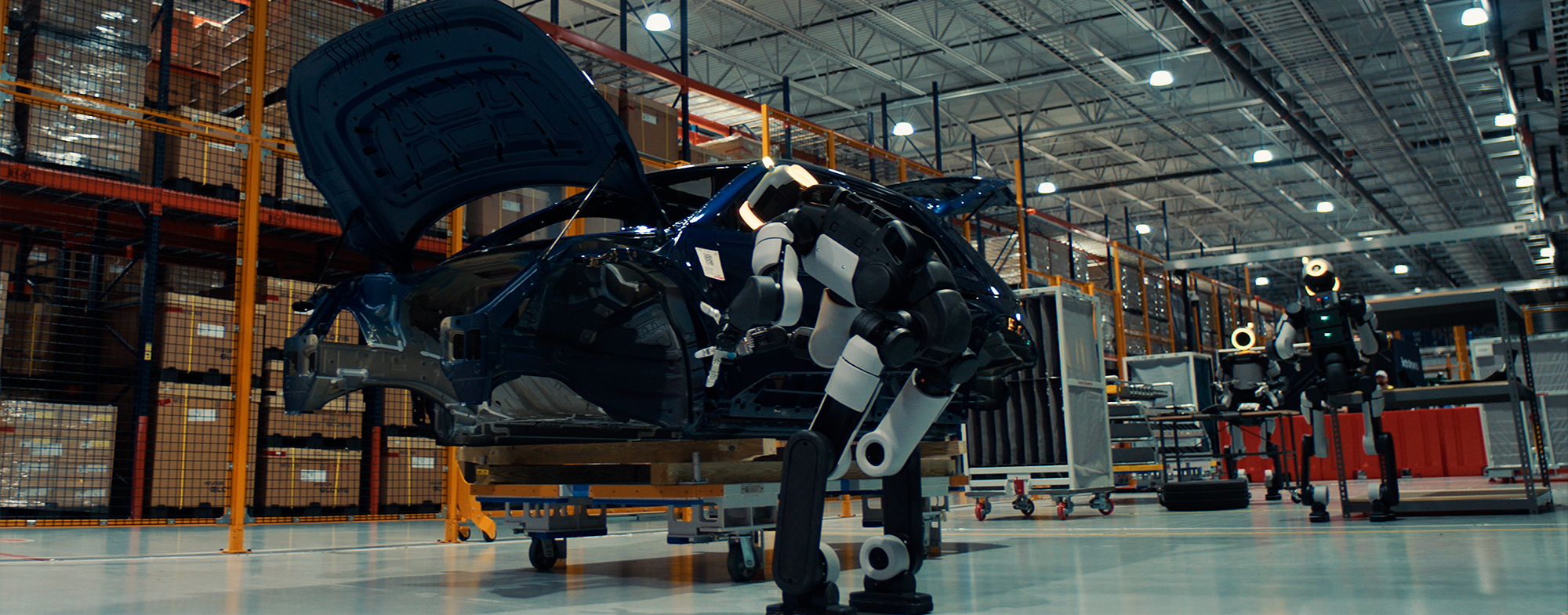 Boston Dynamics Atlas performing a task at an automotive manufacturing plant