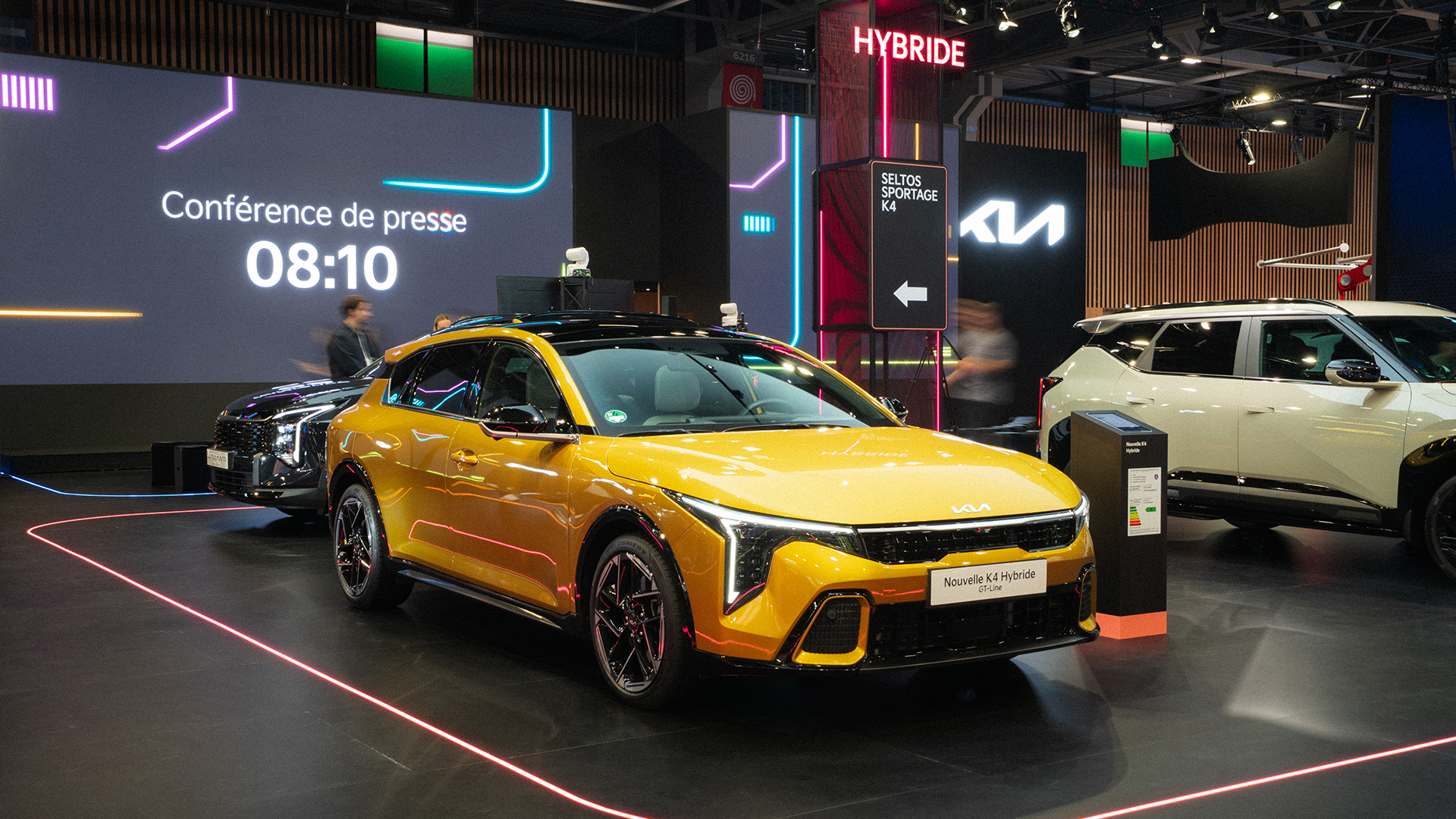 Kia K4 vehicle displayed at the 2026 Paris Motor Show exhibition hall