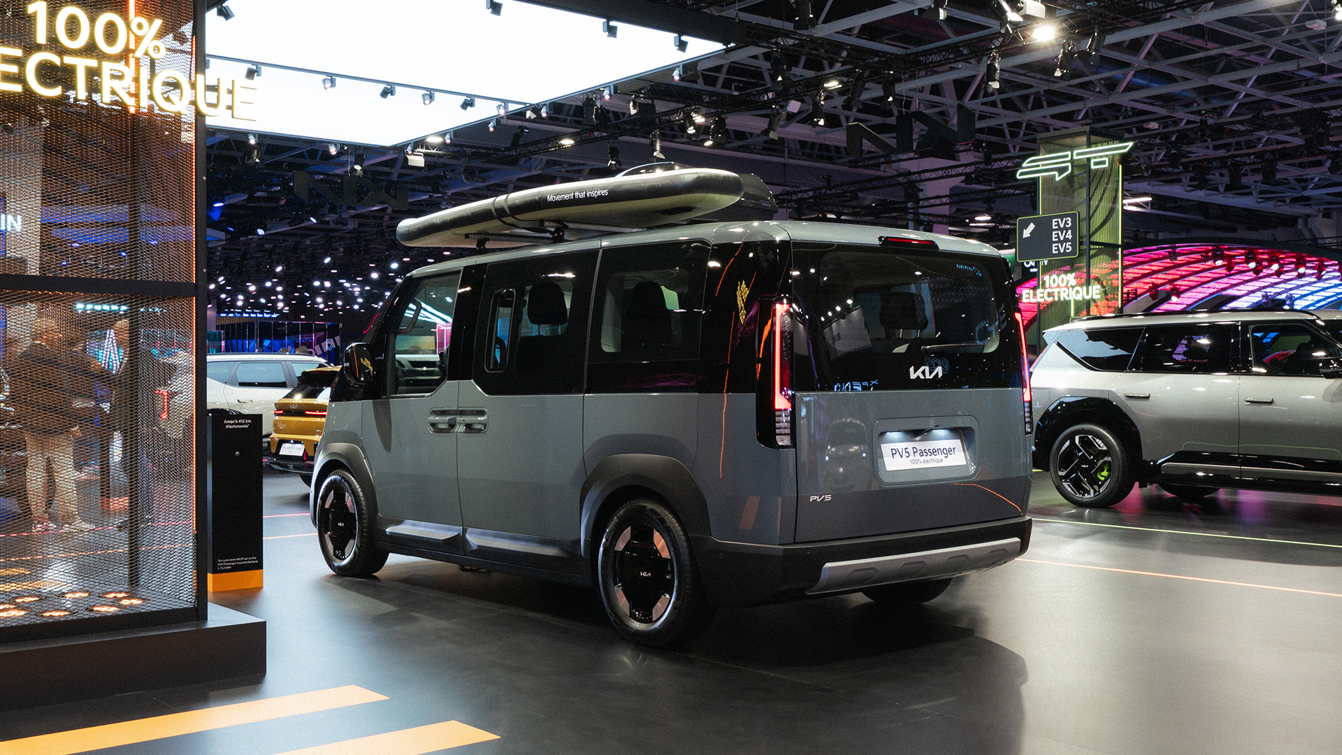 Rear three-quarter view of the Kia PV5 displayed at the 2026 Paris Motor Show exhibition hall
