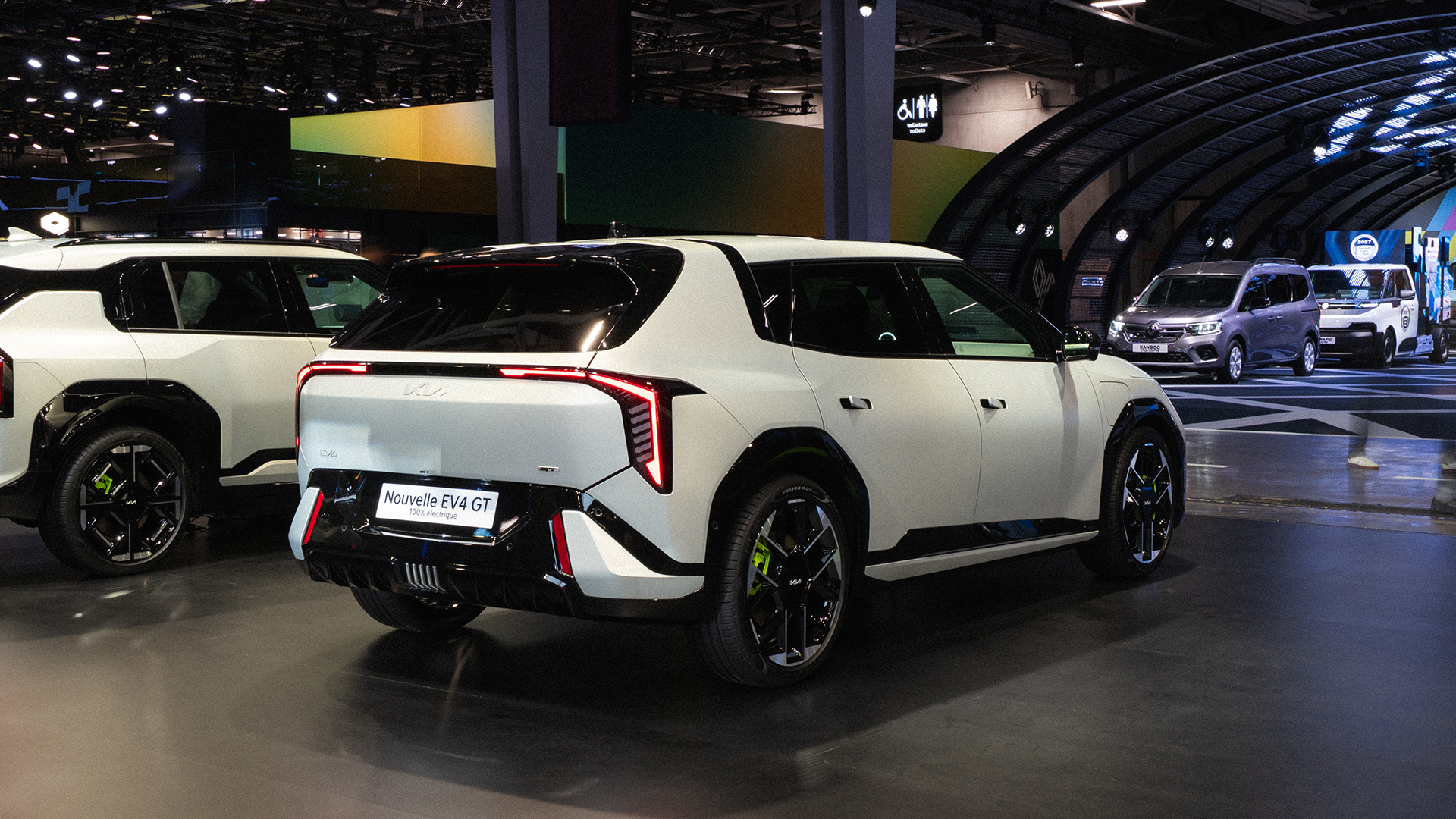 Rear three-quarter view of the Kia EV4 displayed at the 2026 Paris Motor Show exhibition hall