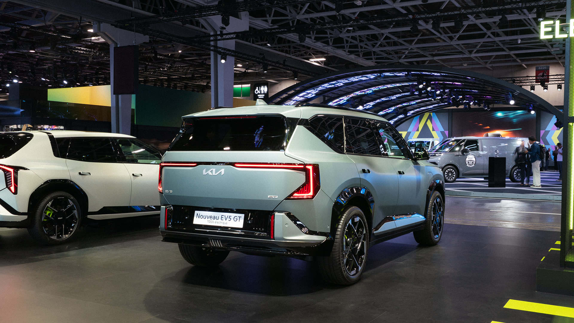 A rear three-quarter view of the Kia EV5 displayed at the 2026 Paris Motor Show venue.