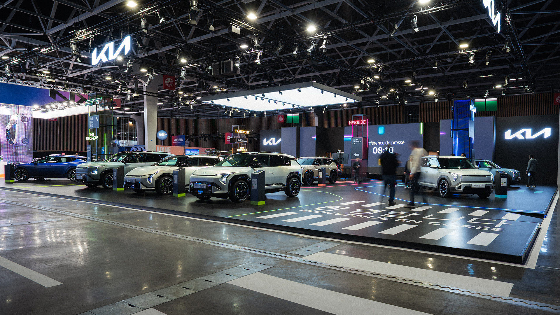 Kia booth with SUVs, Korean crosswalk graphic and Bienvenue en Corée signage