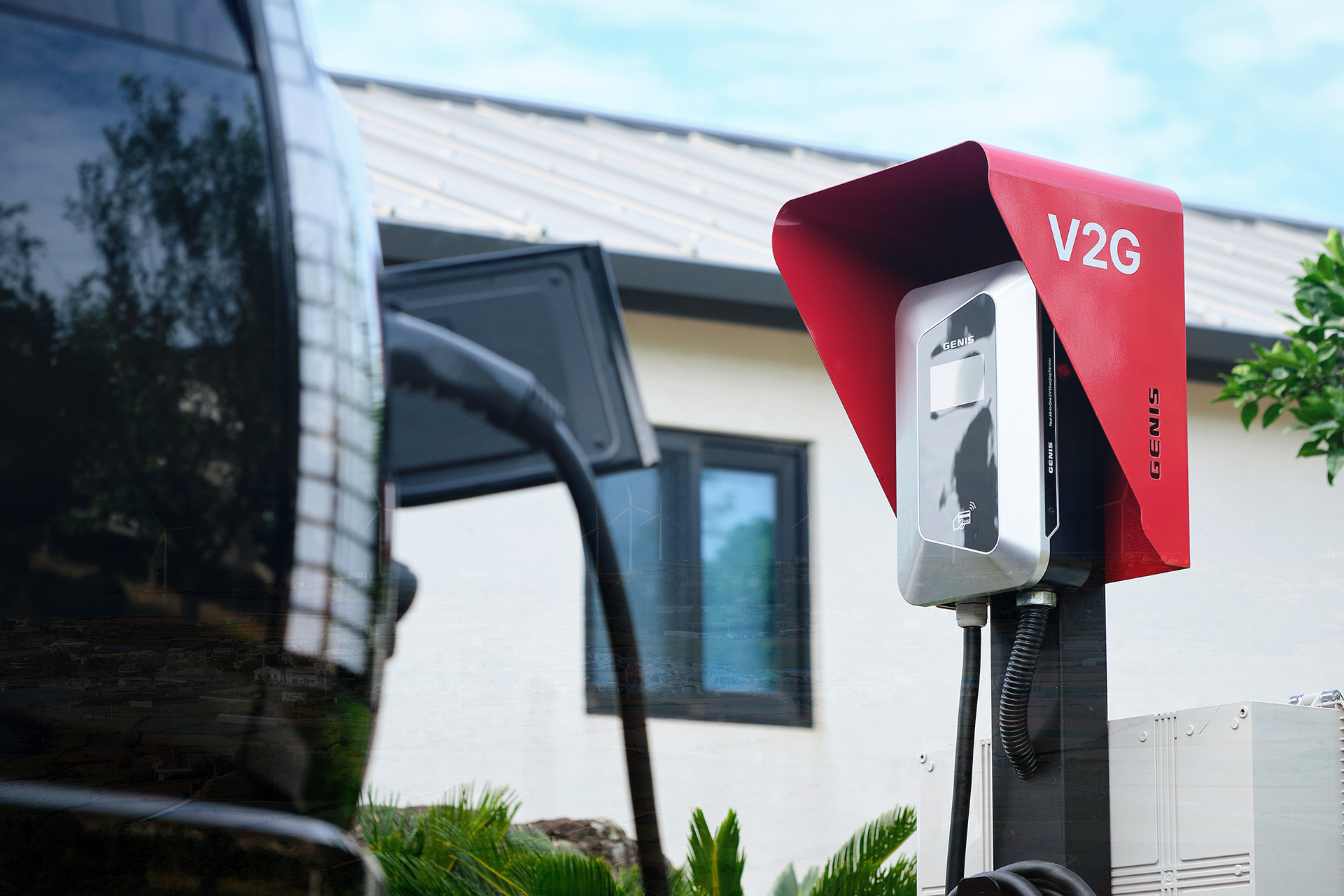 Electric vehicle parked at a charging station in front of a building