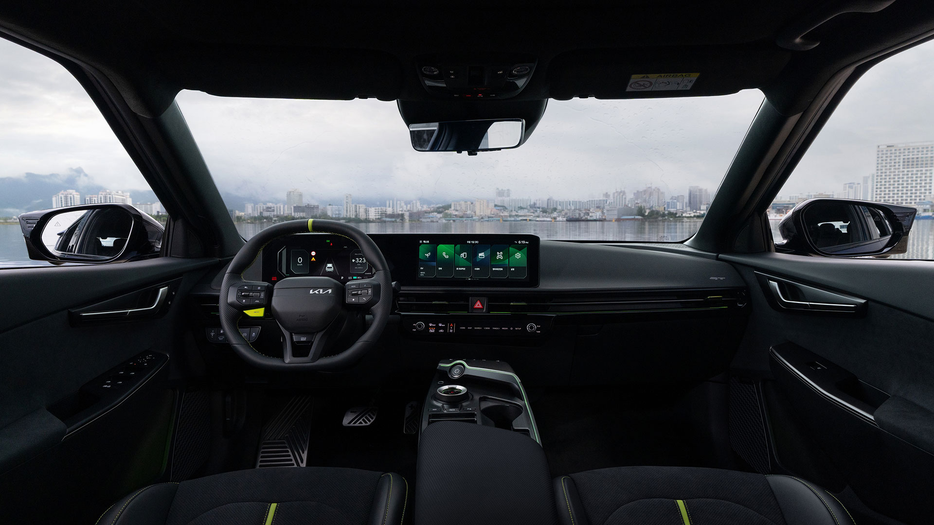 Interior of an EV6 GT featuring dual digital displays and neon green accent seats